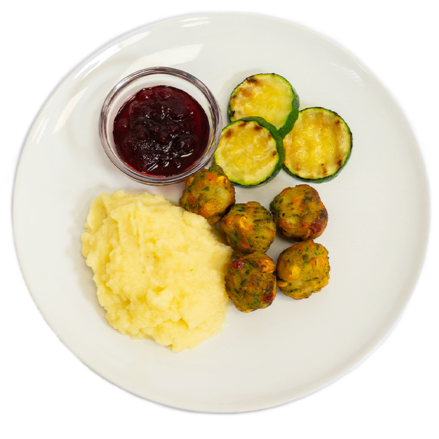 Ein weißer Teller mit Gemüsebällchen, einer Portion Kartoffelbrei, gebratenen Zucchini-Scheiben und einer kleinen Schale Preiselbeermarmelade.